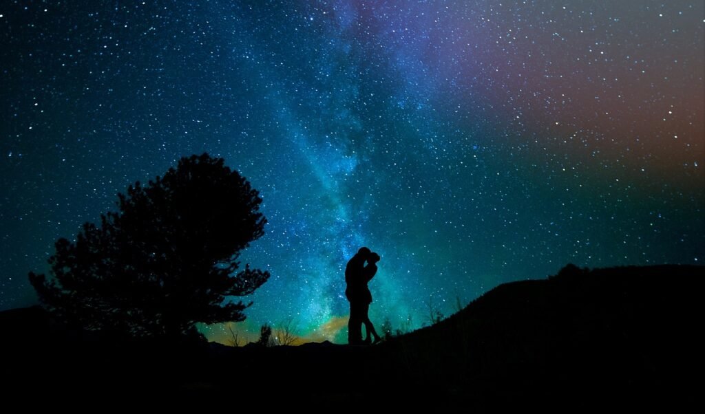 Lovers embraced under the night sky.