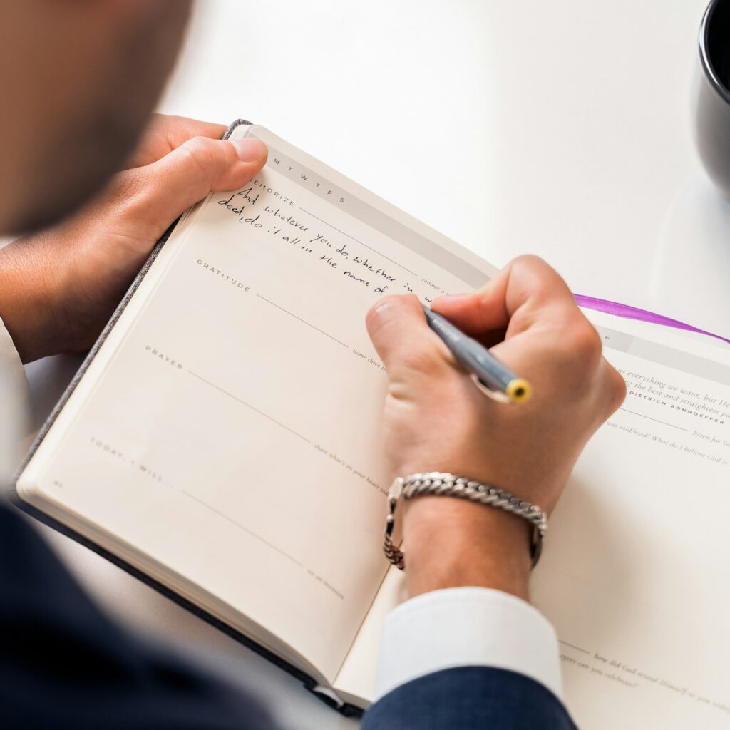 person writing on white paper