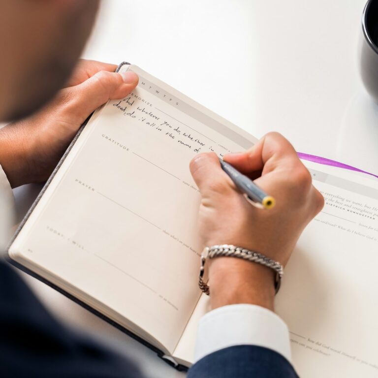 A person master journaling on white pages