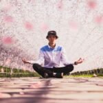 A young man in a hat meditates to prove manifesting in your life works