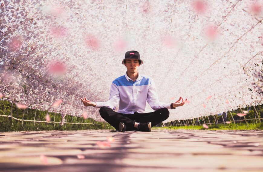 A young man in a hat meditates to prove manifesting in your life works