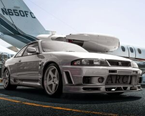 A silver sports car parked on the tarmac with a private jet in the background, all from visualization exercises