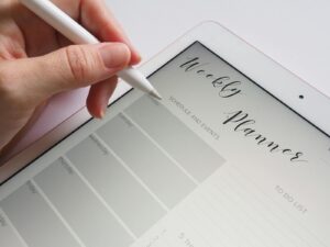 A stylus writing in a digital weekly planner on a tablet screen is ideal for organization.