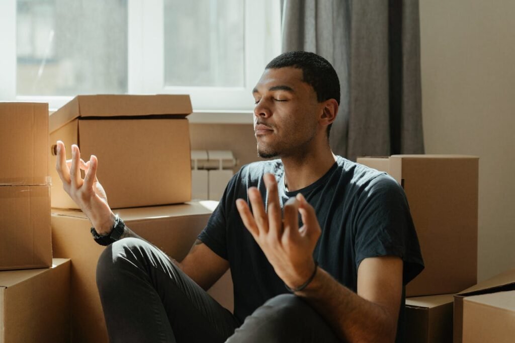 a young man sitting with crossed legs during powerful law of attraction meditating